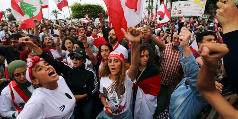 Demonstrators gesture and chant slogans during an anti-government protest in the southern city of Tyre