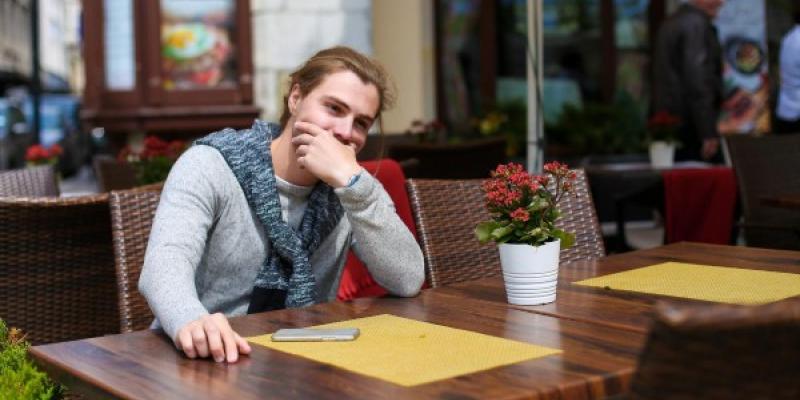 Persona con autismo sentada en la terraza de un restaurante 