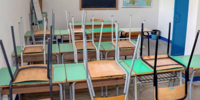 USO Aula de colegio cerrada con todas las sillas sobre las mesas