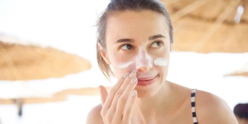 Protección de las cremas solares faciales Persona aplicando cremas solares faciales