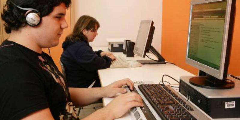 EBAU: Estudiante ciego usa el ordenador en clase con auriculares para recibir las indicaciones de voz 