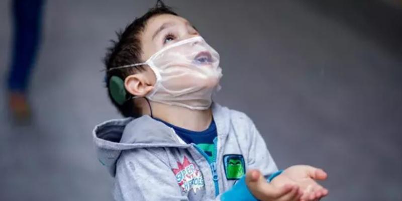 Niño con sordera que lleva puesto un implante coclear y una mascarilla transparente / Archivo de Europa Press