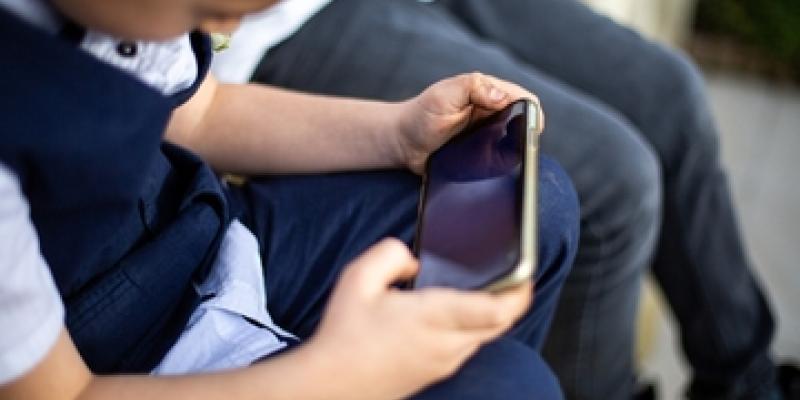 Imagen de un niño con un teléfono móvil/envatoelements El aprendizaje en casa de los niños