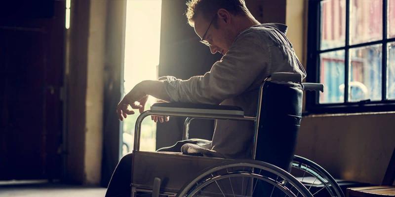 Un hombre con discapacidad sentado sobre su silla de ruedas