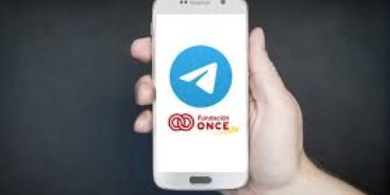 Una palma de la mano sostiene un móvil en el que se el logotipo de Fundación ONCE en su pantalla 