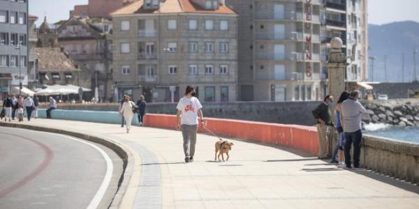 Varias personas pasean por el Paseo Marítimo de Sanxenxo. Beatriz Ciscar / Europa Press