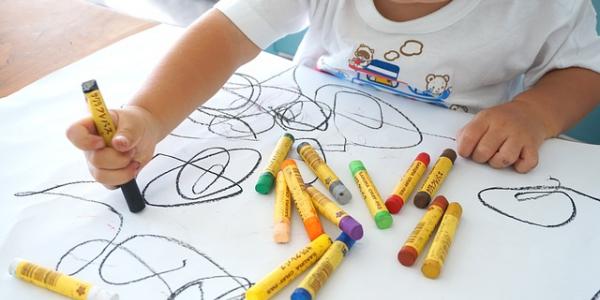 Niño dibujando con ceras de colores / Imagen de creandotuprovincia.es