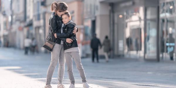Una madre abraza a su hijo adolescente | Foto de 123RF/eplisterra