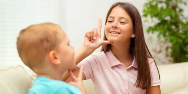 Dos niños comunicándose en lengua de signos