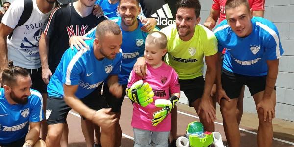 Cristian con los jugadores del Málaga Fútbol Club.