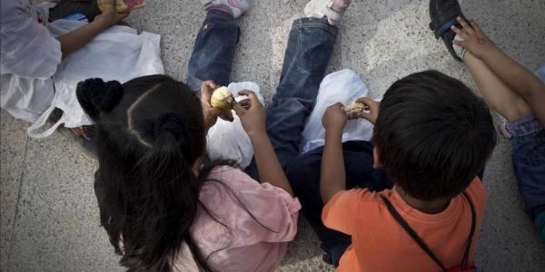 Unos niños, en la calle, a la hora de la merienda. / CARLOS MONTAÑÉS para EL PERIÓDICO