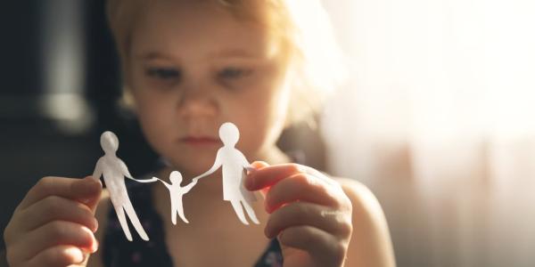 Niña con un recortable de una familia