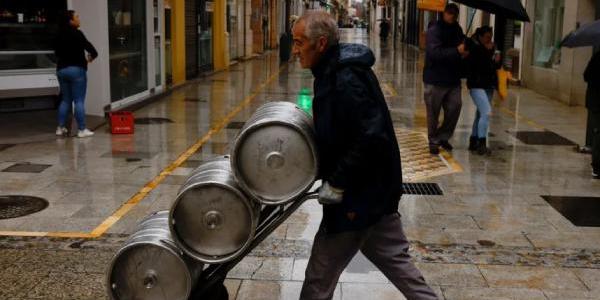 Empleado transportando un barril de cerveza