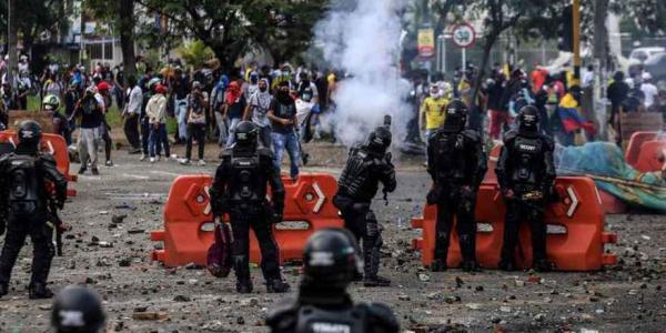 Manifestantes chocan con la policía antidisturbios durante una protesta contra un proyecto de reforma tributaria lanzado por el presidente colombiano Iván Duque, en Cali Agencia AFP