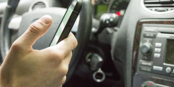 Persona usando el teléfono móvil al volante